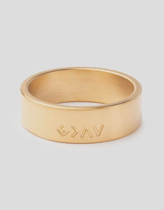 Gold ring with 'GYAV' engraving on a light gray background