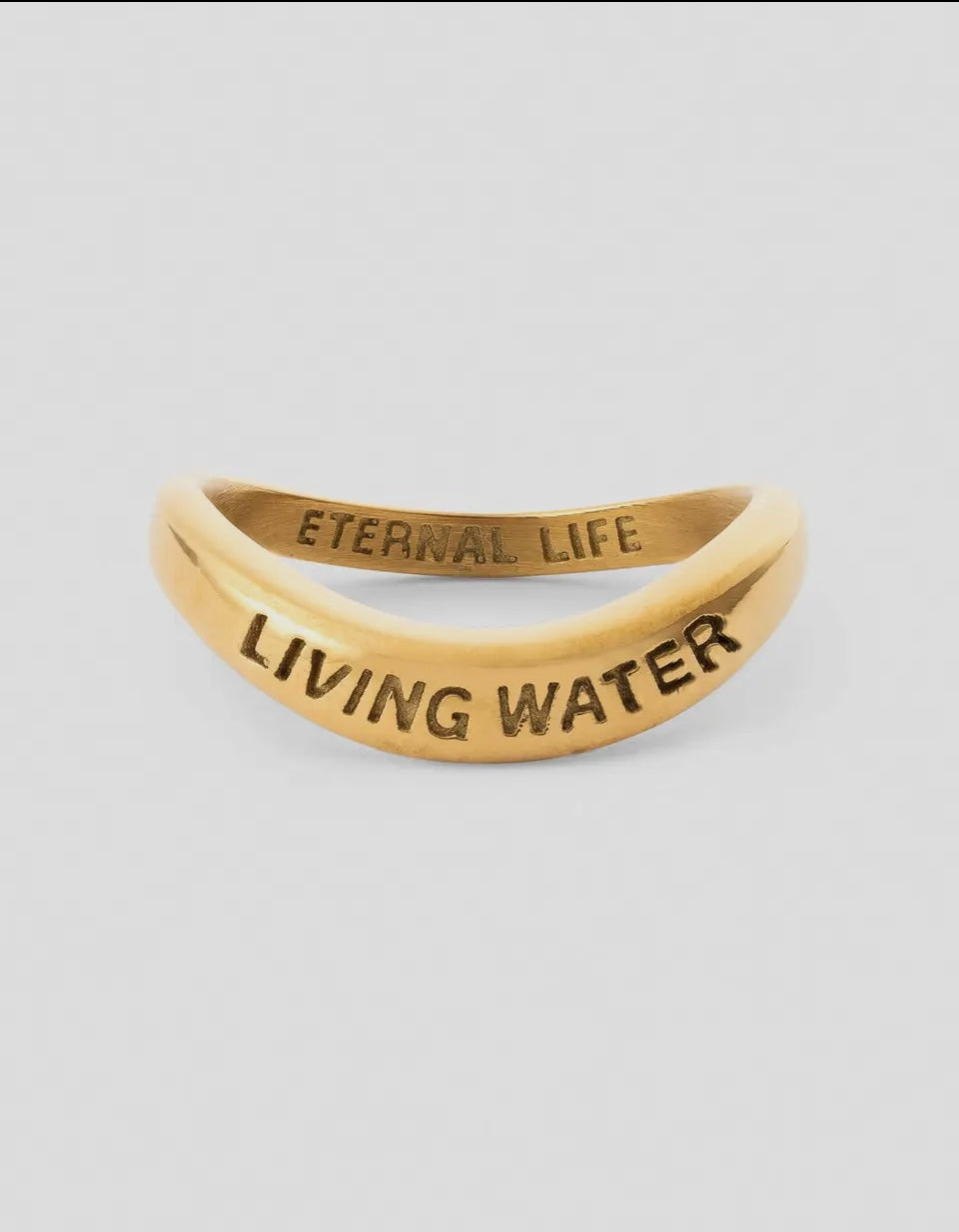 Gold ring with engraved text 'Eternal Life' and 'Living Water' on a light gray background